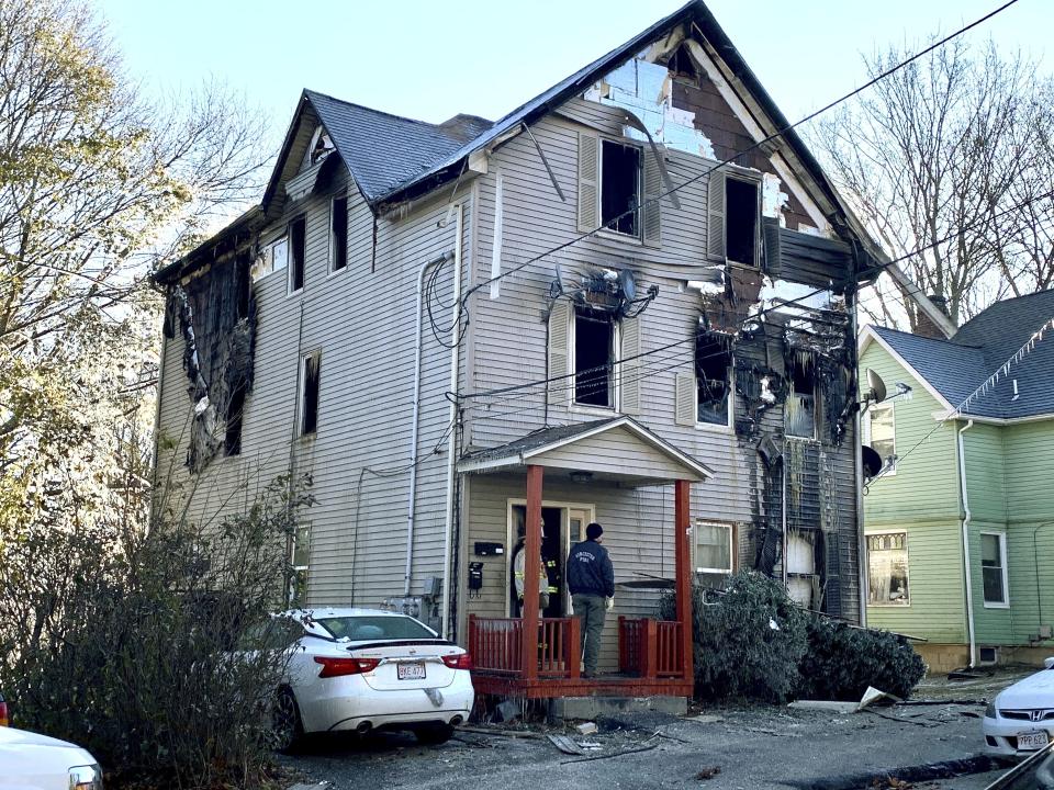 Investigators work the scene of an overnight fire that killed Lt. Jason Menard, Wednesday, Nov. 13, 2019 in Worcester, Mass. Menard, 39, and his crew became trapped on the top floor of the three-story home after the fire was reported at about 1 a.m., Worcester Fire Chief Michael Lavoie told a news conference. Menard helped two members of his crew escape but he himself was unable to get out. (Christine Peterson/Worcester Telegram & Gazette via AP)