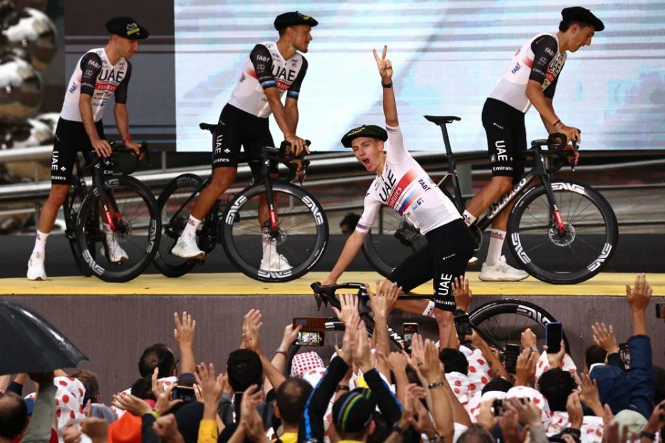 UAE Team Emirates Slovenian rider Tadej Pogacar C flashes a victory sign as he exits the stage during the official teams presentation near the Guggenheim Museum Bilbao in Bilbao northern Spain on June 29 2023 two days prior to the start of the 110th edition of the Tour de France cycling race Photo by AnneChristine POUJOULAT  AFP Photo by ANNECHRISTINE POUJOULATAFP via Getty Images