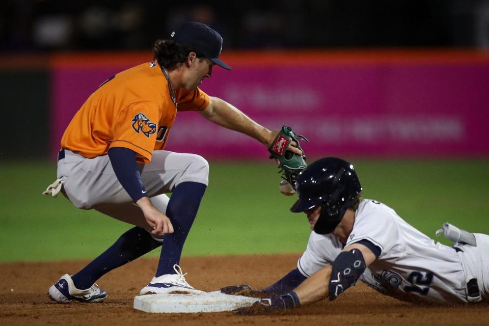 Former Thousand Oaks High shortstop Jacob Wilson (left), playing shortstop for the Double-A Midland RockHounds, attempts to tag Corpus Christi runner Chad Stevens in a game earlier this month.