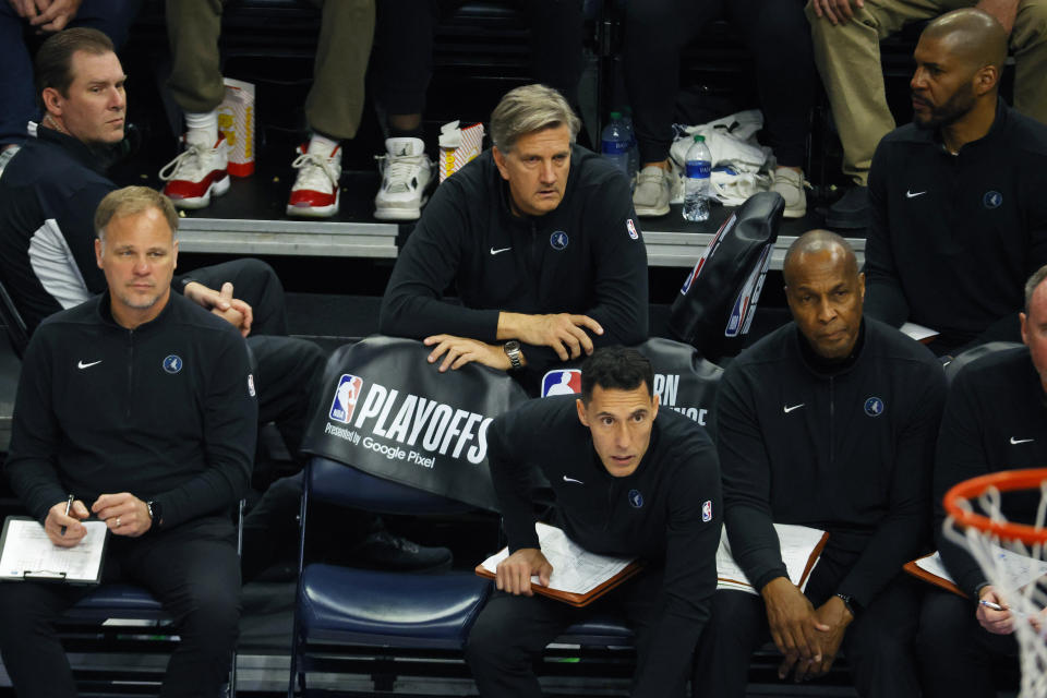 Minnesota Timberwolves head coach Chris Finch, top center, watches from the bench during the second half of Game 2 of the NBA basketball Western Conference finals against the Dallas Mavericks, Friday, May 24, 2024, in Minneapolis. (AP Photo/Bruce Kluckhohn)