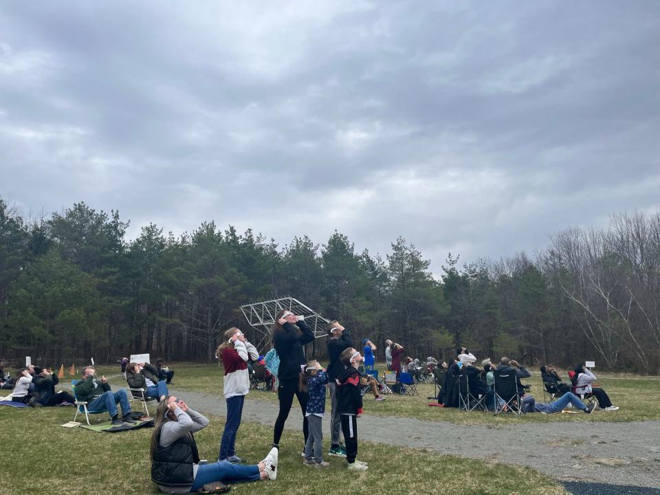 Viewers get a quick glimpse between the clouds as the eclipse begins at Kopernik Observatory & Science Center in Vestal April 8, 2024.