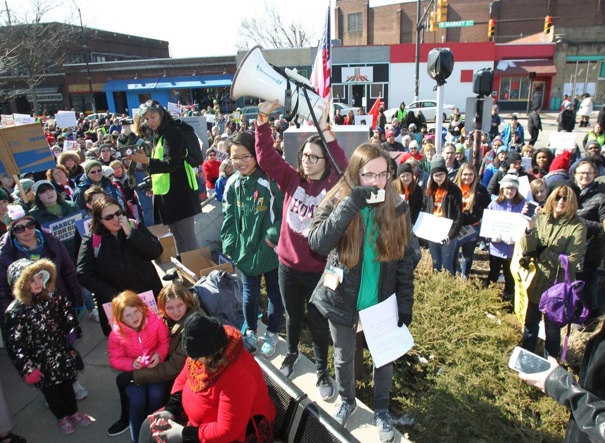 in this file photo, Meredith Gallagher, 15, of Cuyahoga Falls, the organizer of the Akron March for Our Lives event to end gun violence, yells into the microphone as she leads a rally at Highland Square before the hundreds of participants march to the Summit County Courthouse Saturday, March 24, 2018, in Akron.