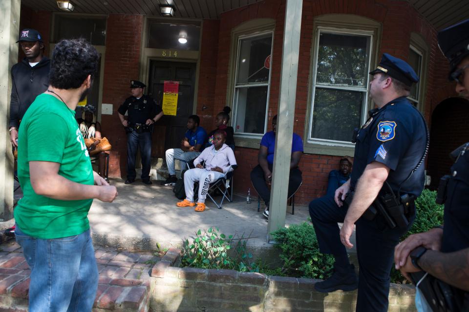 Residents wait outside of 820 to 808 N. Adams St. in Wilmington after their homes were condemned Monday, May 16, 2022.