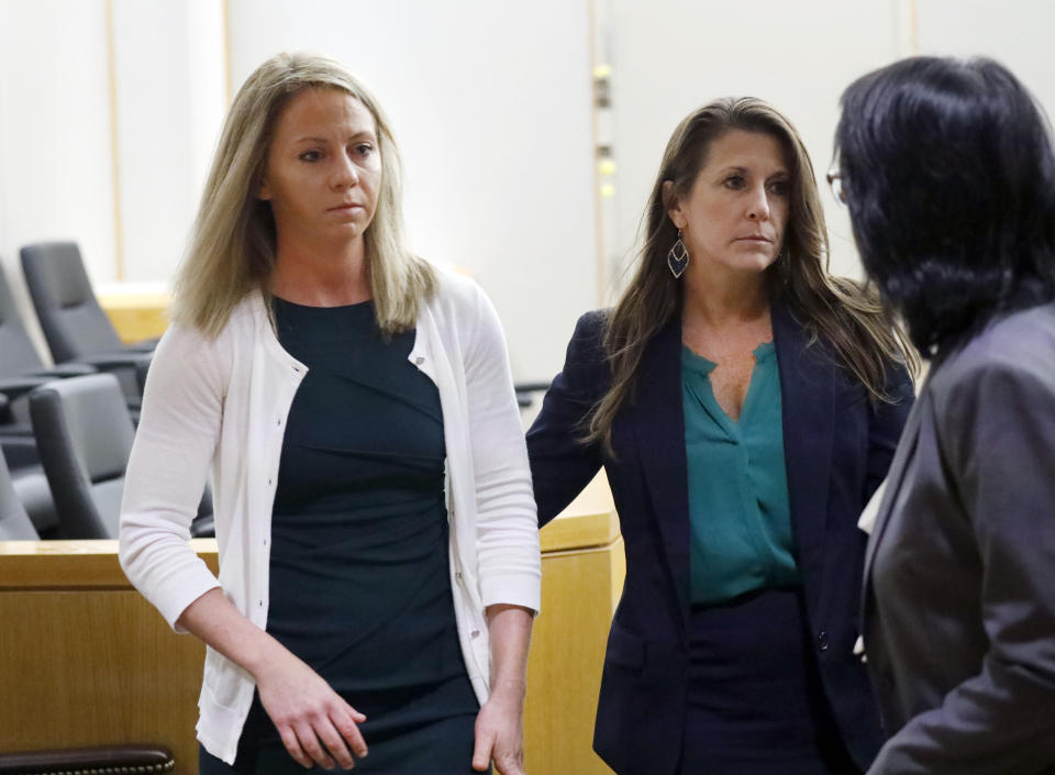 Former Dallas police officer Amber Guyger leaves the courtroom during a break in morning proceedings in her murder trial, Tuesday, Sept. 24, 2019, in Dallas. Guyger is accused of shooting her unarmed black neighbor in his Dallas apartment. (Tom Fox/The Dallas Morning News via AP, Pool)