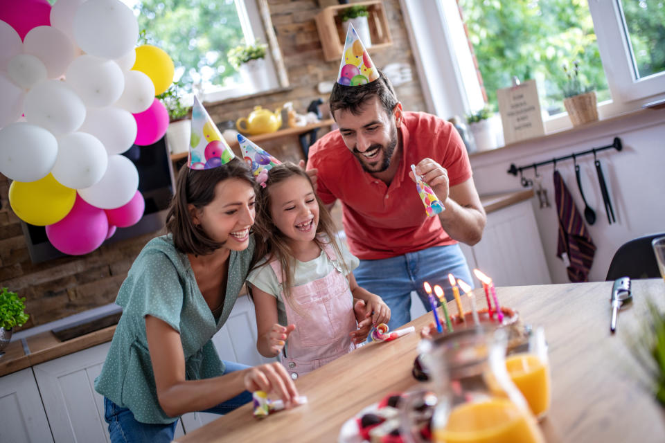 Celebration and family concept, happy family having birthday party at home