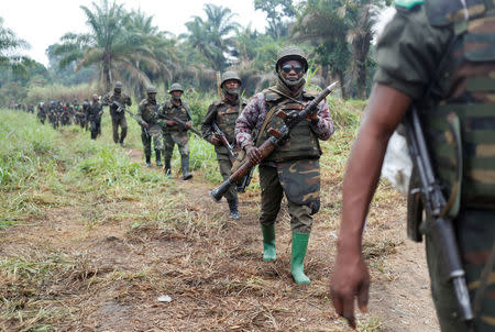 Congolese soldiers from the Armed Forces of the Democratic Republic of Congo (FARDC) walk in line after the army took over an ADF rebel camp, near the town of Kimbau, North Kivu Province, Democratic Republic of Congo, February 20, 2018. REUTERS/Goran Tomasevic/Files