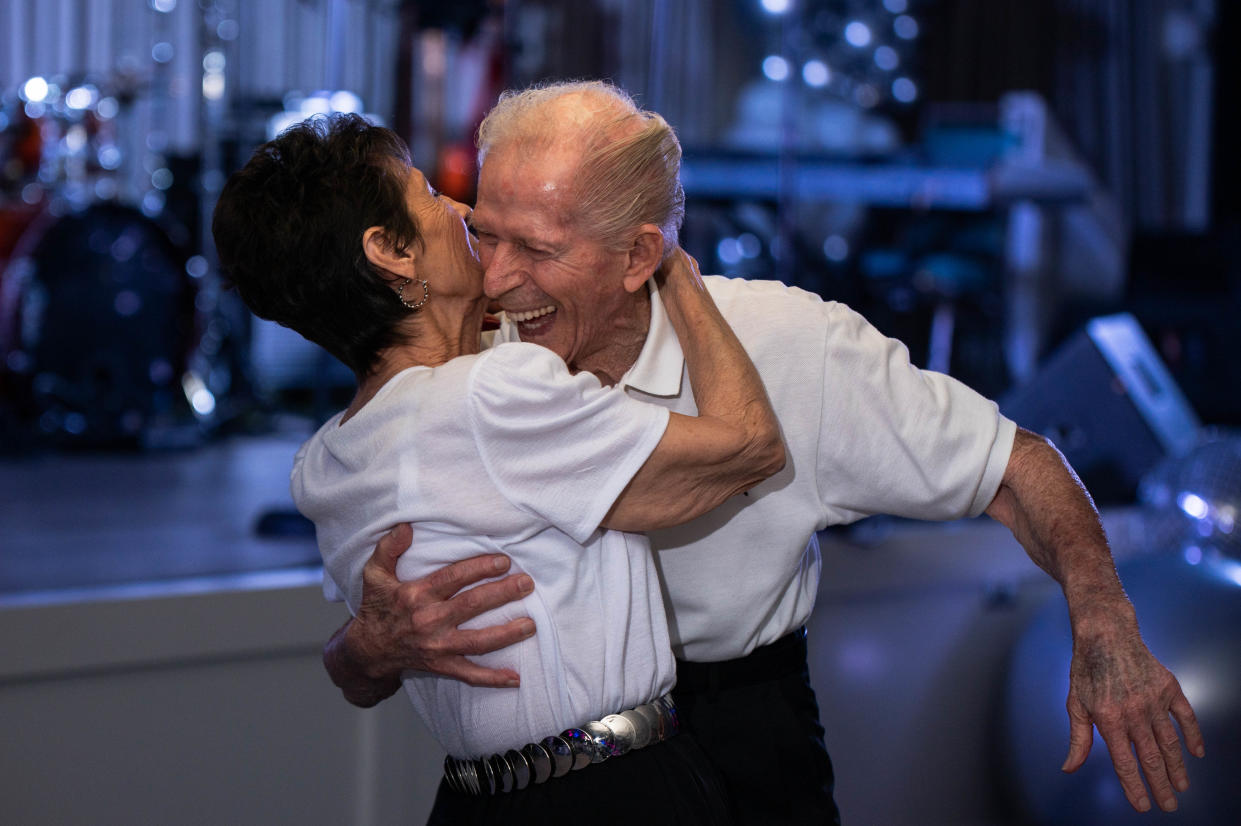 Pete Belice smiles while hugging his wife of 64 years, Angie, during a dance party celebrating the 50th anniversary of Kings Point on Jan. 12 in the development's main clubhouse in Delray Beach. The Belices, who teach ballroom dancing at Kings Point, said they have enjoyed living in the community during the winter months for the last 10 years.