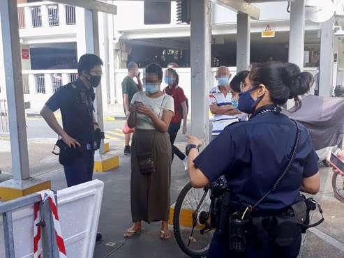 A female foreigner had not comply with safe distancing measures implemented at the market section of the hawker centre at Block 505 Jurong West Street 52 on 12 April, 2020. (PHOTO: NEA) 
