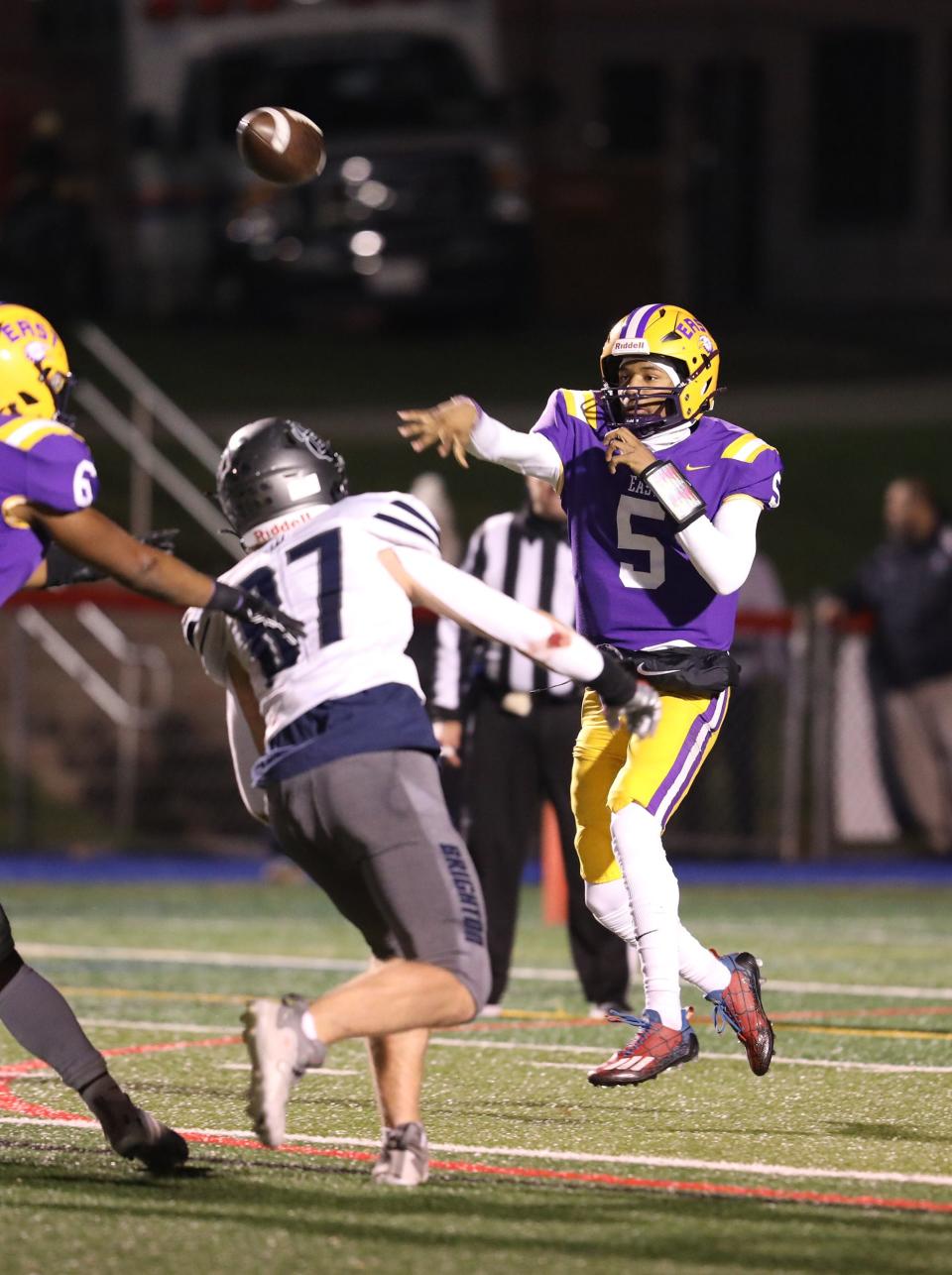 EAS/WOIS Quarterback Zymier Jackson gets a pass off as Brighton's Thomas Welker heads towards him.