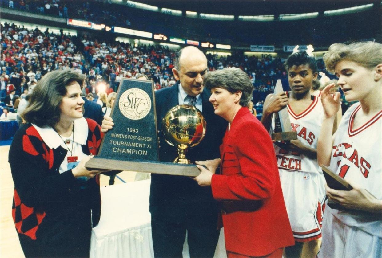 Coach Marsha Sharp accepts the championship trophy after the 1993 Lady Raiders clinched a 78-71 victory over Texas to earn the tournament title for the second straight season.