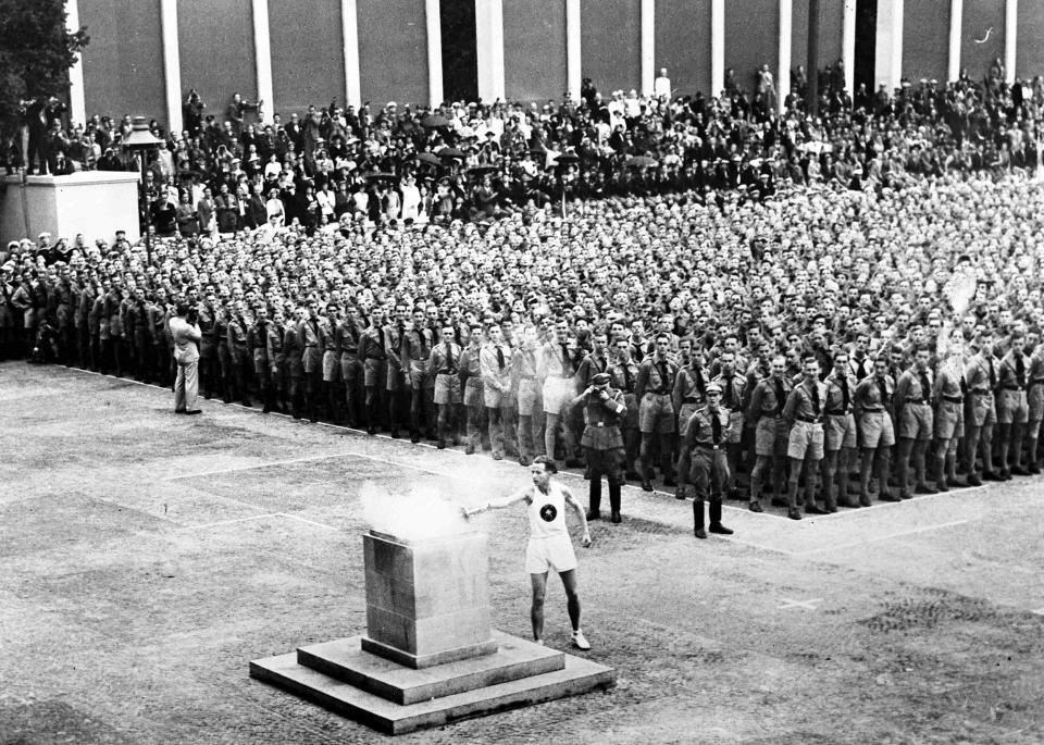 The Olympic flame is lit in Lustgarten, Berlin on Aug. 1, 1936, where it was guarded by members of Hitler Youth before being brought to the Olympic stadium for the opening of the games. (AP)