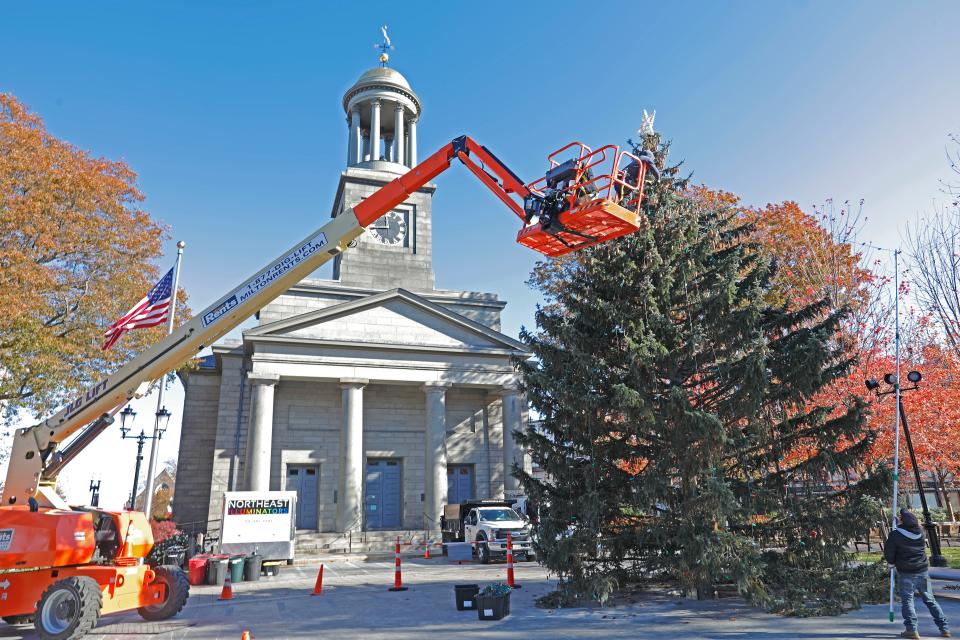 A bucket truck is needed to trim the top of the Christmas tree in Quincy Center. The tree was brought in almost two full weeks before Thanksgiving in 2021.