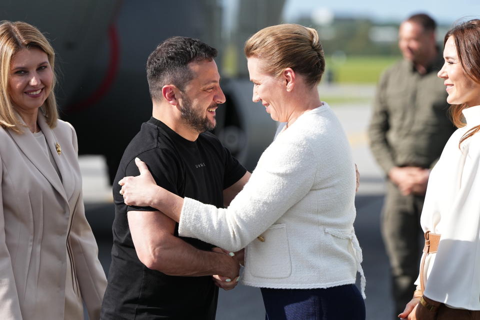 Ukrainian President Volodymyr Zelenskyy and his wife Olena Selenska, left, are welcomed by Denmark's Crown Princess Mary, right, and Prime Minister Mette Frederiksen at Skrydstrup Airbase, in Vojens, Denmark, Sunday, Aug. 20, 2023. (Mads Claus Rasmussen/Ritzau Scanpix via AP)