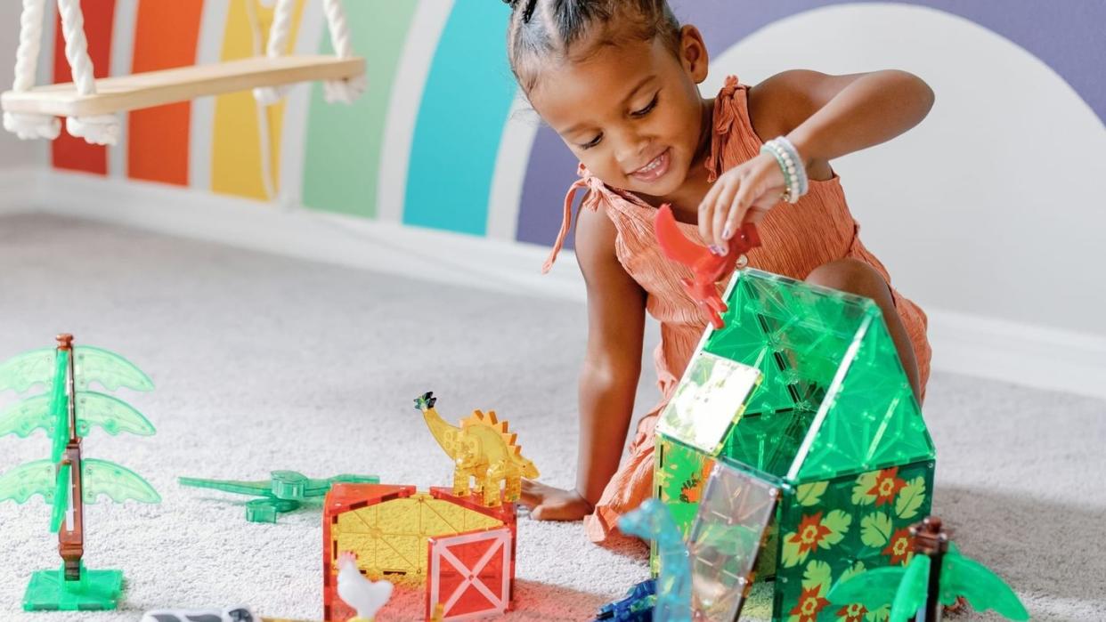 girl playing with magnatiles