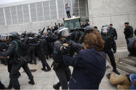 <p>Civil guards clear people away from the entrance of a sports center, assigned to be a polling station by the Catalan government in Sant Julia de Ramis, near Girona, Spain, Oct. 1, 2017. (Photo: Francisco Seco/AP) </p>