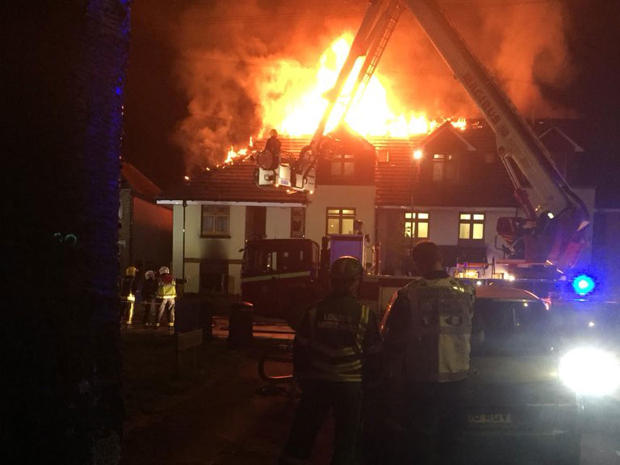 Pictures from the scene show flames pouring from the roof of the building: London Ambulance Service HART