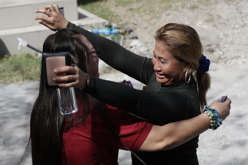 Women celebrate after their relatives were found acquitted after hearing the verdict outside a court in Camp Bagong Diwa, Taguig city, Philippines, Thursday, Dec. 19, 2019. The Philippine court on Thursday found key members of a powerful political clan guilty of a 2009 massacre in a southern province that left 57 people, including 32 media workers, dead in a brazen act that horrified the world. (AP Photo/Aaron Favila)