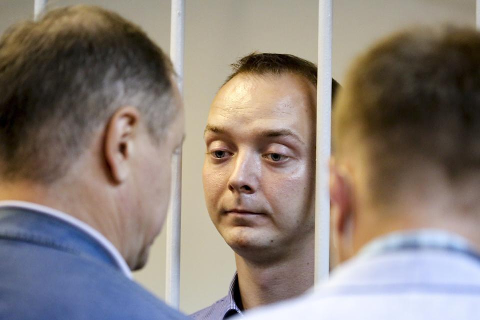 Ivan Safronov, an adviser to the director of Russia's state space corporation, stands behind bars in a courtroom in Moscow, Russia, Tuesday, July 7, 2020. Safronov, a former journalist who worked as an adviser to the director of the Russian state space corporation, pleaded innocent to the treason charges against him. Ivan Safronov, a former journalist who served as an adviser to Roscosmos head Dmitry Rogozin, was detained in Moscow by agents of the Federal Security Service (FSB), the main KGB successor agency. (Sofia Sandurskaya, Moscow News Agency photo via AP)