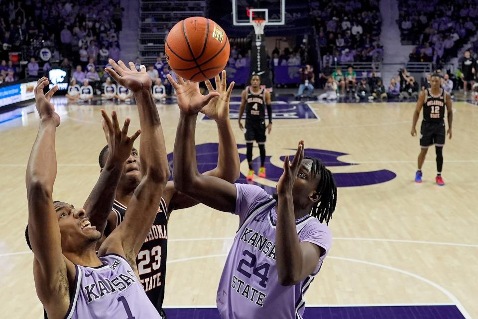 Kansas State forwards David N'Guessan (1) and Arthur Kaluma (24) battle Oklahoma State center Brandon Garrison (23) for a rebound during their game Saturday at Bramlage Coliseum.