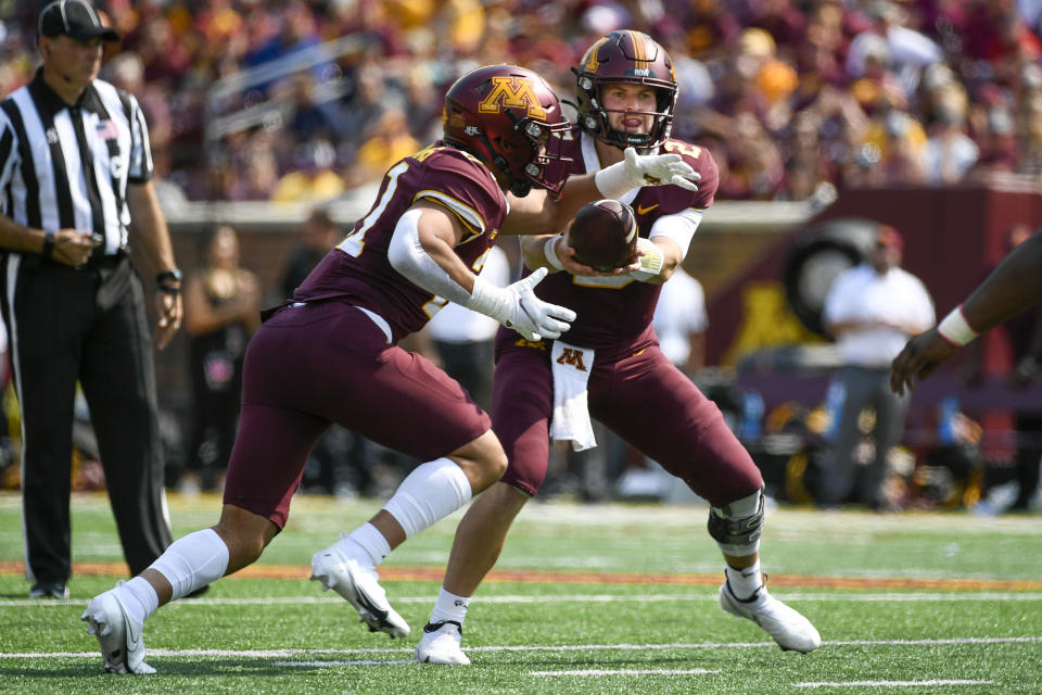 Minnesota quarterback Tanner Morgan hands off to running back Bryce Williams during the first half of an NCAA college football game against against Miami of Ohio Saturday, Sept. 11, 2021, in Minneapolis. Minnesota won 31-26. (AP Photo/Craig Lassig)