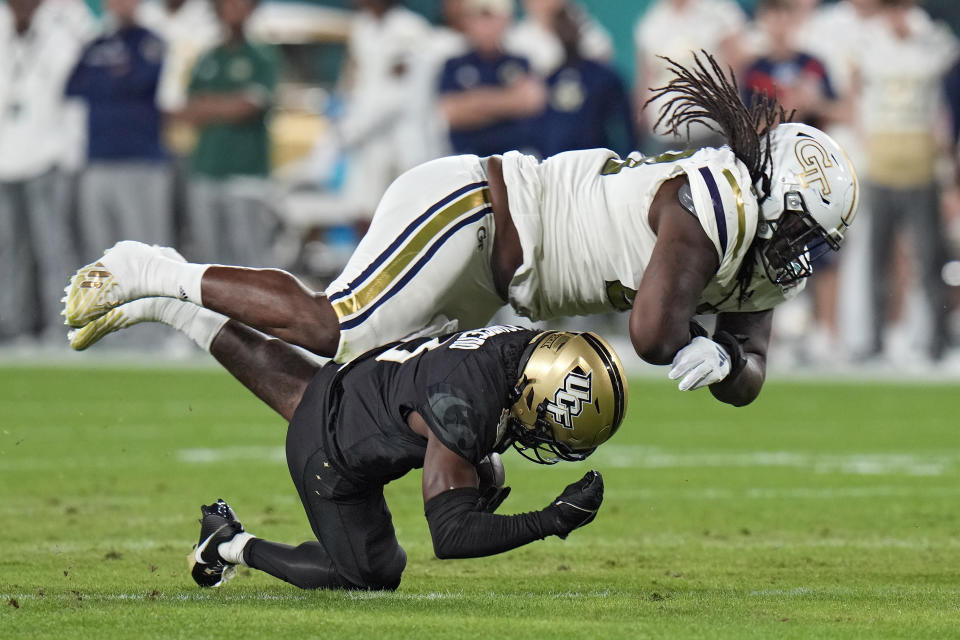 Georgia Tech defensive lineman Zeek Biggers (88) takes down Central Florida wide receiver Xavier Townsend (3) after a catch during the first half of the Gasparilla Bowl NCAA college football game Friday, Dec. 22, 2023, in Tampa, Fla. (AP Photo/Chris O'Meara)