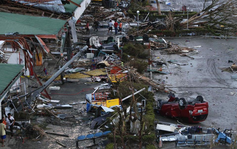 Debris litter a damaged airport after super Typhoon Haiyan battered Tacloban city in central Philippines November 9, 2013. Possibly the strongest typhoon ever to hit land devastated the central Philippine city of Tacloban, killing at least 100 people, turning houses into rubble and leveling the airport in a surge of flood water and high wind, officials said on Saturday. The toll of death and damage from Typhoon Haiyan on Friday is expected to rise sharply as rescue workers and soldiers reach areas cut off by the massive, fast-moving storm which weakened to a category 4 on Saturday. REUTERS/Erik De Castro (PHILIPPINES - Tags: DISASTER ENVIRONMENT TRANSPORT)