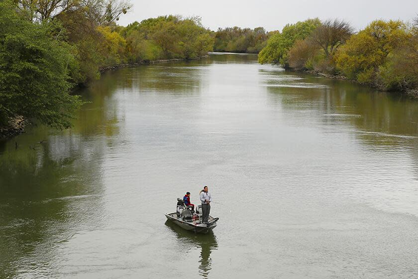 People fish in the Sacramento-San Joaquin River Delta's Elk Slough near Courtland, Calif.