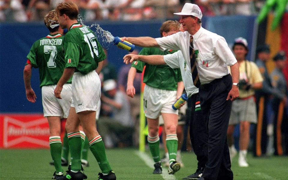 Republic of Ireland manager Jack Charlton splashes water on Tommy Coyne, - Sportsifle