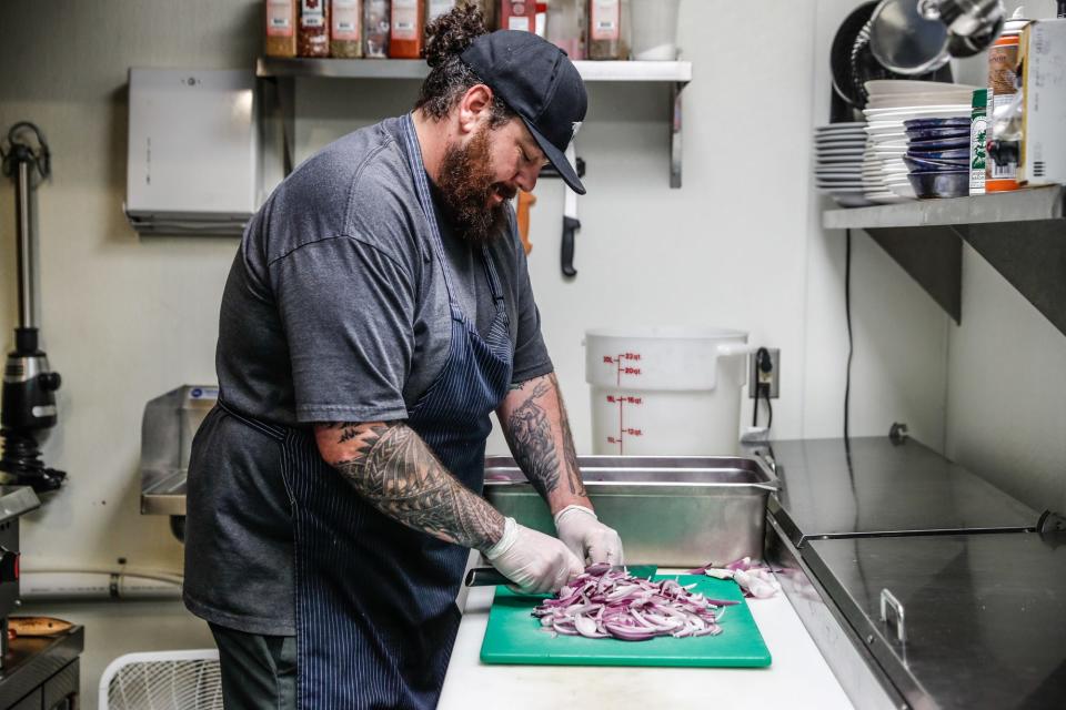 Chef Samir Mohammad chops onions in 2021 at the 9th Street Bistro in Noblesville. He is one of two Indy area chefs named a James Beard regional semifinalist.