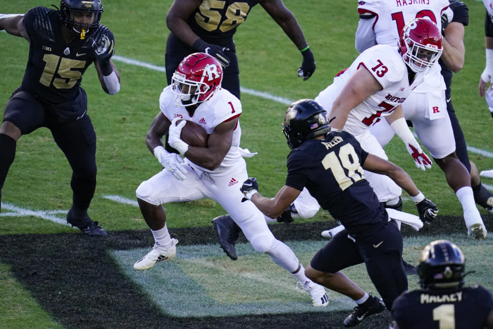 Rutgers running back Isaih Pacheco (1) runs past Purdue cornerback Cam Allen (18) during the first quarter of an NCAA college football game in West Lafayette, Ind., Saturday, Nov. 28, 2020. (AP Photo/Michael Conroy)