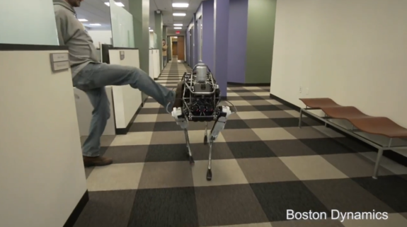 A screenshot from Boston Dynamics' latest YouTube video shows the company's four-legged robot, Spot, getting kicked in belly.