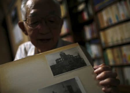 Akira Yamada, a 89-year-old Hiroshima atomic bombing survivor, former college professor and ex-president of Fukushima University, shows an undated photo of Atomic Bomb Dome on his album during an interview with Reuters at his home in Fukushima Japan, July 30, 2015. REUTERS/Toru Hanai