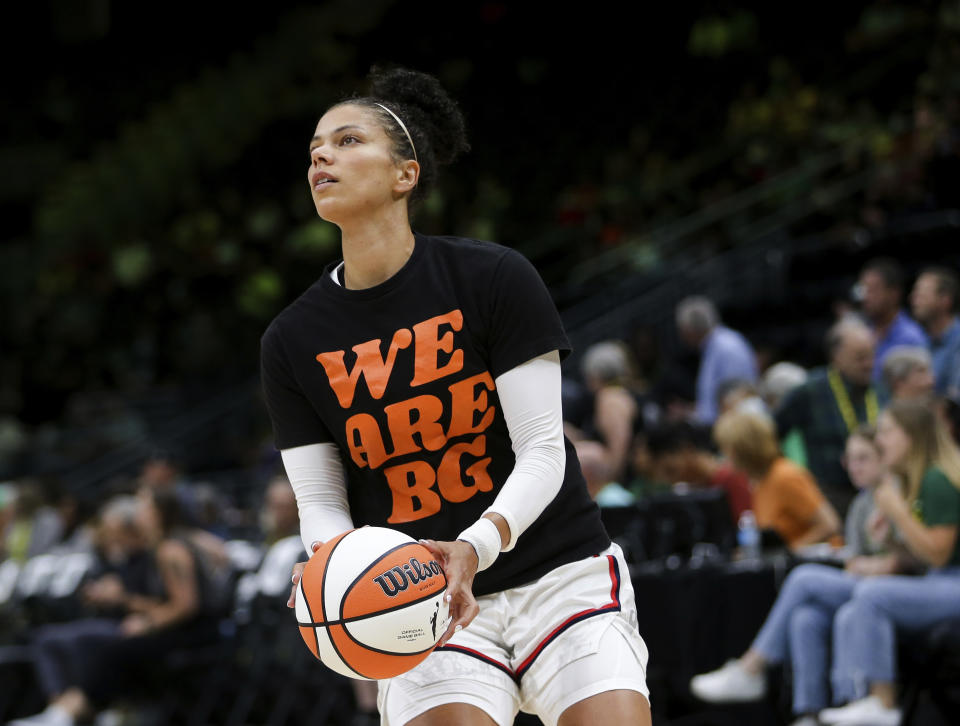 FILE - Washington Mystics forward Alysha Clark wears a "We Are BG" T-shirt, referring to WNBA player Brittney Griner, before Game 1 of the team's WNBA basketball first-round playoff series against the Seattle Storm on Thursday, Aug. 18, 2022, in Seattle. For weeks after Griner's arrest at a Moscow airport in February, where Russian authorities said a search of her luggage revealed vape cartridges containing cannabis oil, her supporters kept a relatively low profile in hopes her case would be quickly resolved. (AP Photo/Lindsey Wasson, File)