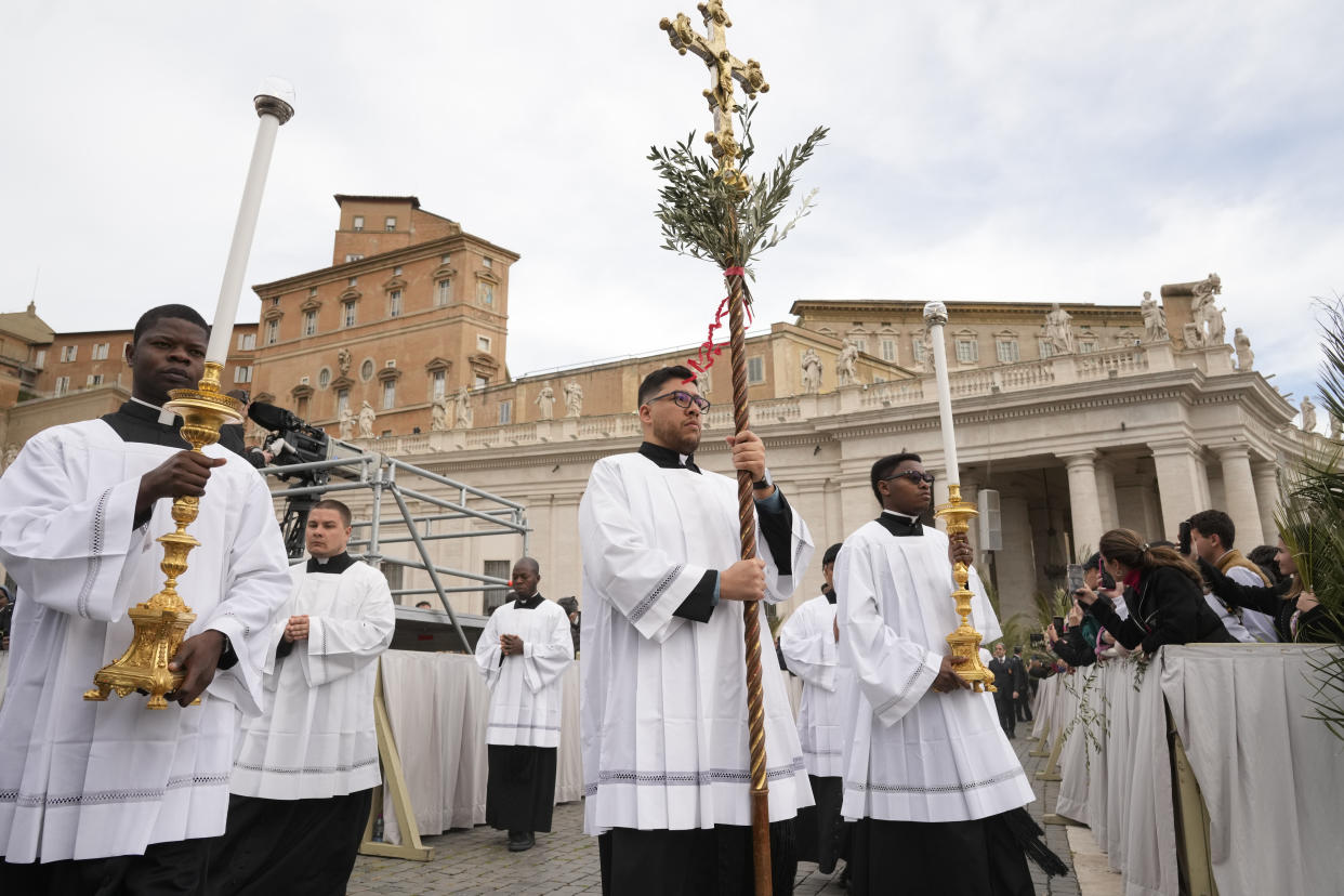 Palm bearers arrive in a procession at the start of the Palm Sunday's mass celebrated by Pope Francis in St. Peter's Square at The Vatican Sunday, April 2, 2023 a day after being discharged from the Agostino Gemelli University Hospital in Rome, where he has been treated for bronchitis, The Vatican said. The Roman Catholic Church enters Holy Week, retracing the story of the crucifixion of Jesus and his resurrection three days later on Easter Sunday. (AP Photo/Andrew Medichini)