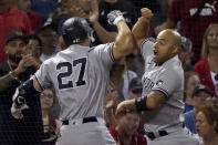 New York Yankees designated hitter Giancarlo Stanton (27) celebrates with teammate Rougned Odor after hitting a three-run home run during the third inning of a baseball game against the Boston Red Sox at Fenway Park, Friday, Sept. 24, 2021, in Boston. (AP Photo/Mary Schwalm)