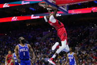 Toronto Raptors' Chris Boucher (25) dunks past Philadelphia 76ers' James Harden (1) during the first half of Game 5 in an NBA basketball first-round playoff series, Monday, April 25, 2022, in Philadelphia. (AP Photo/Matt Slocum)