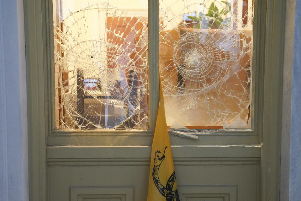 FILE - Windows are cracked and broken insurrectionists loyal to President Donald Trump as they stormed the U.S. Capitol on Jan. 6, 2021, in Washington. (AP Photo/John Minchillo, File)