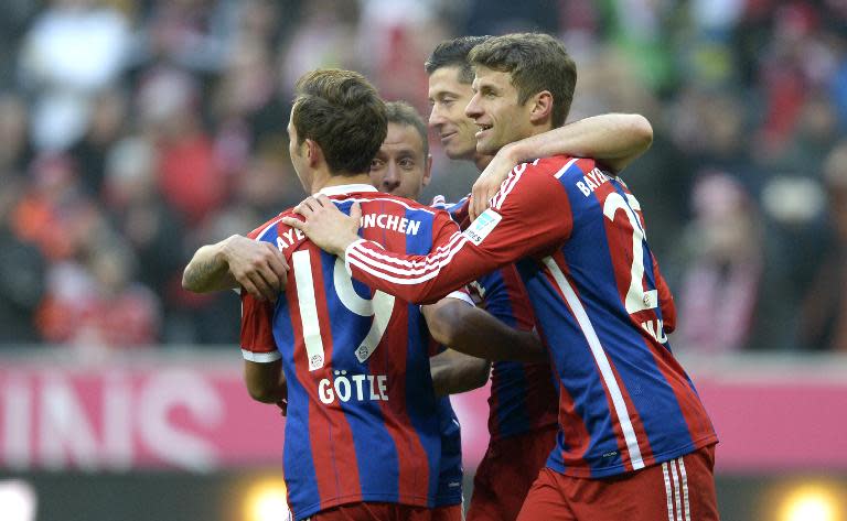 (L-R) Bayern Munich's Mario Goetze, Rafinha, Robert Lewandowski and Thomas Mueller celebrate after the sixth goal for Munich during their German first division Bundesliga football match against Hamburger SV in Munich, Germany, on February 14, 2015