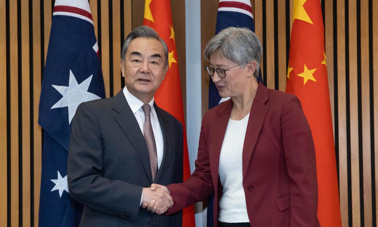 <span>Australian foreign affairs minister Penny Wong (right) shakes hands with China's foreign minister Wang Yi in Canberra on Wednesday. Wong raised the case of Australian writer Dr Yang Hengjun, who has been detained in China since 2019.</span><span>Photograph: Mike Bowers/The Guardian</span>