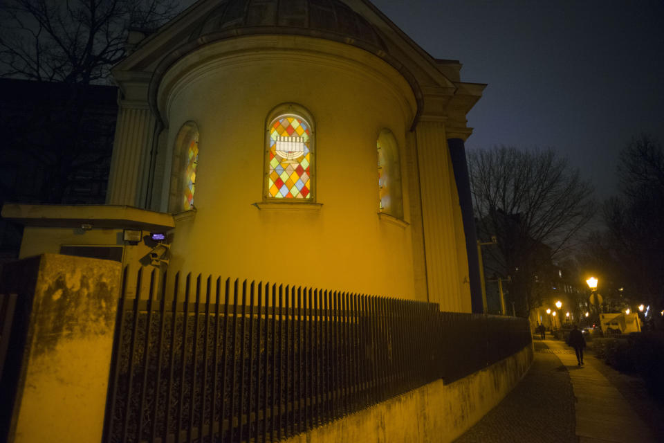 In this Wednesday, March 20, 2019 photo, the windows of the so-called youth-synagogue, the remaining building of the 'Fraenkelufer' synagogue, are illuminated in Berlin. The synagogue was able to receive about 2000 prayers before it was destroyed by the Nazis. In the German capital, efforts are underway to rebuild the synagogue. (AP Photo/Markus Schreiber)