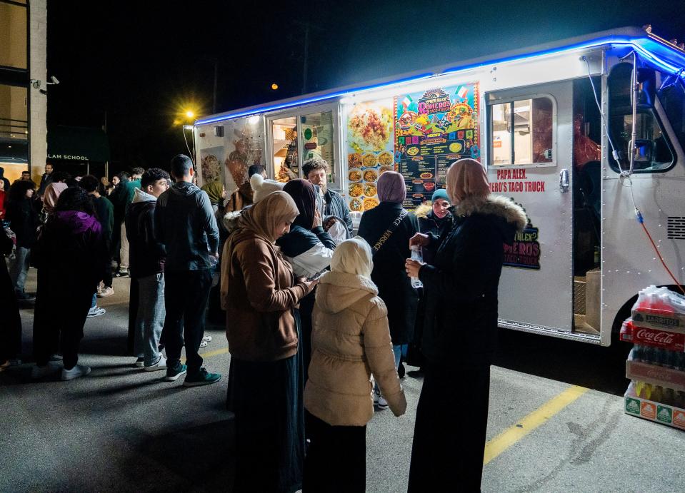 Families wait for food at the Suhoor Food Truck Festival, which took place at night to accommodate for Muslims who are fasting for Ramadan Friday.