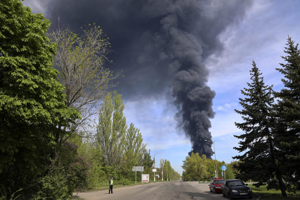 Smoke rises from the oil depot as fire broke out after missiles struck the facility in an area controlled by Russian-backed separatist forces in Makiivka, 15 km (94 miles) east of Donetsk, eastern Ukraine, Wednesday, May 4, 2022. The representative office of the Donetsk People's Republic in the Joint Center for Control and Coordination of the ceasefire regime (JCCC) said on Wednesday that the city of Makiivka was shelled and, according to preliminary data, an oil depot is on fire. (AP Photo/Alexei Alexandrov)