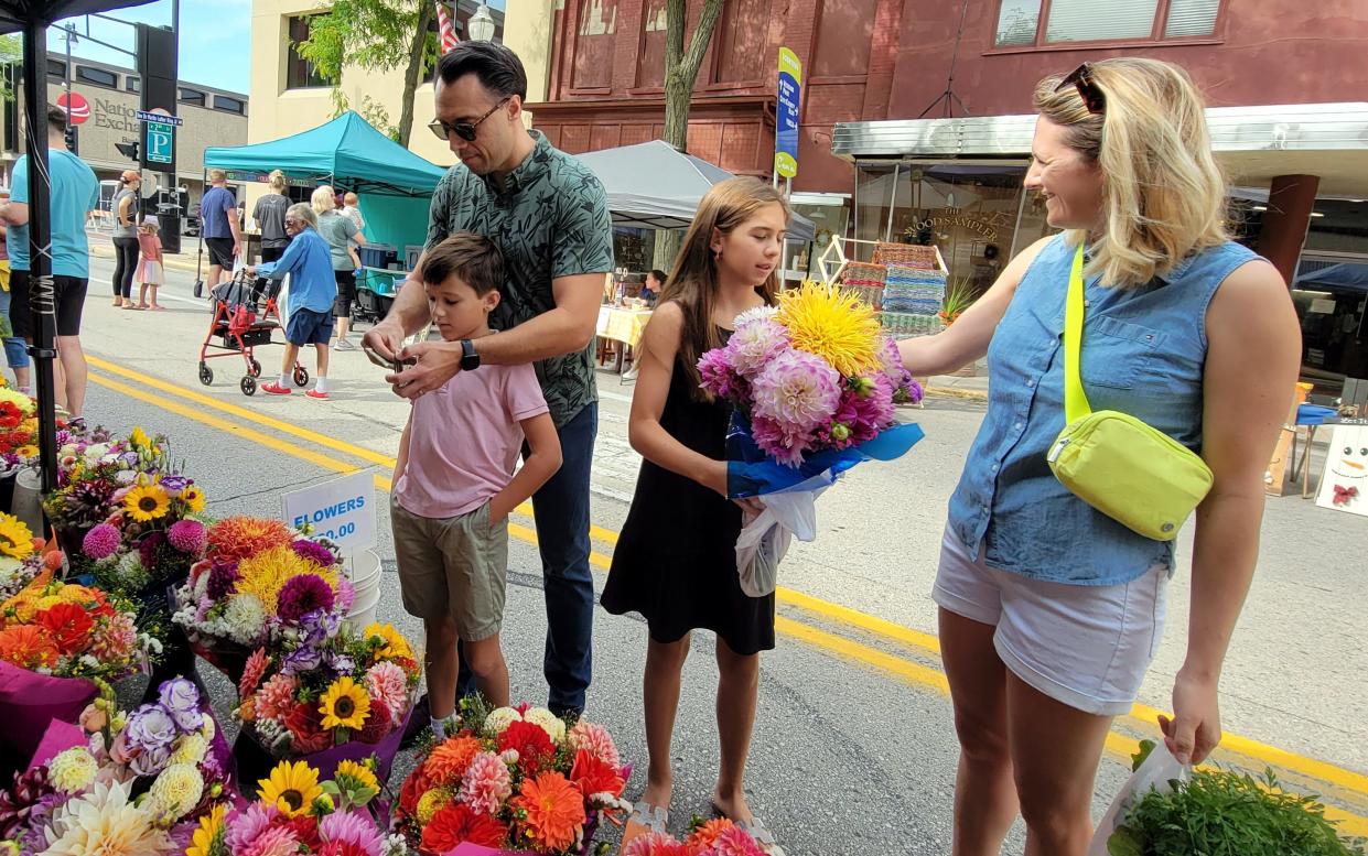 SSM Health Fond du Lac Regional Clinic doctors and Fond du Lac residents, Tadeo Diaz Balderrama and Crystal Kleiber Balderrama support local vendors at the Downtown Fond du Lac Farmers Market.