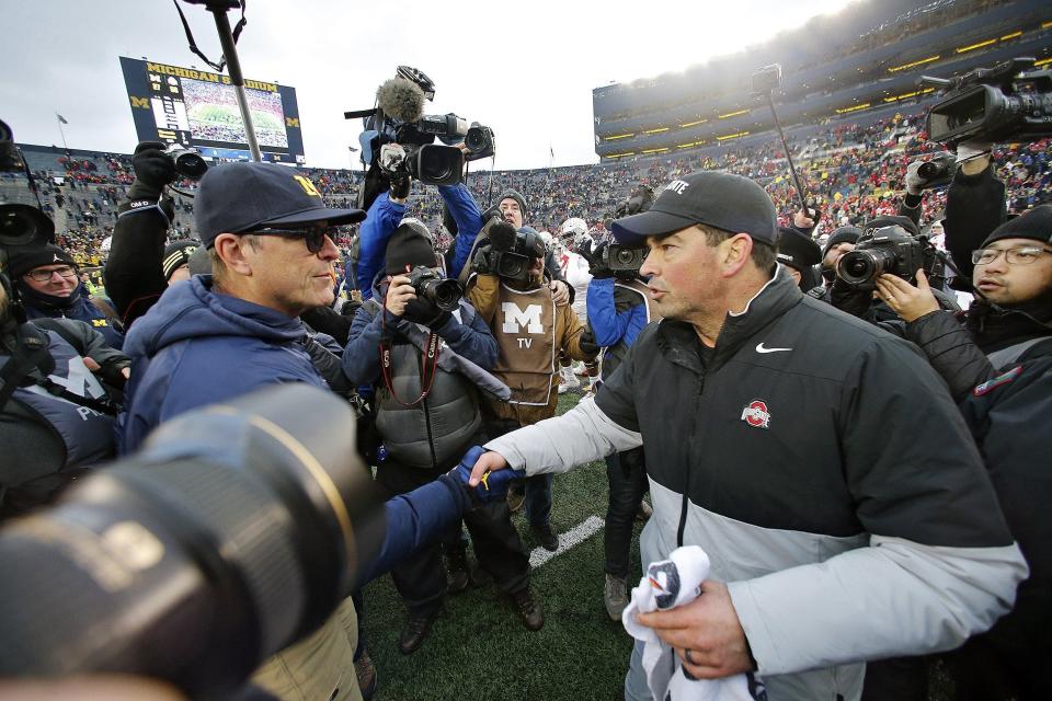 Ohio State coach Ryan Day, right, shakes the hand of Michigan coach Jim Harbaugh after the Buckeyes won 56-27 in 2019.