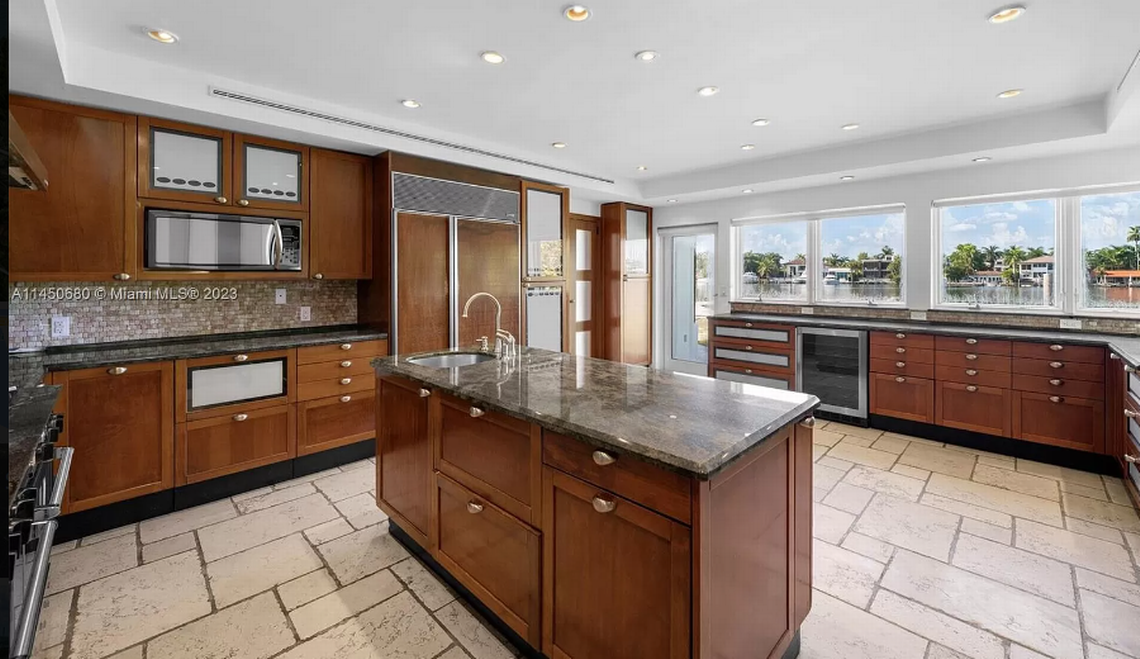 Marketed as a prime site for redevelopment, the Hibiscus Island residence has gone through many chapters. It was first built in 1930. The original entrance of the home is left standing, but the house has been added to throughout the decades with most recently in 2006. Above: Inside the home’s kitchen. Zillow.com; Multiple Listing Service