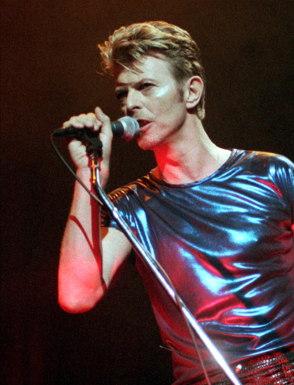 FILE - David Bowie performs during a concert in Hartford, Conn., on Sept. 14, 1995. The many faces and inspirations of David Bowie are getting a permanent home in London. Britain’s Victoria & Albert Museum announced Thursday, Feb. 23, 2023 it has acquired Bowie’s archive of more than 80,000 items as a gift from the late musician’s estate.(AP Photo/Bob Child, File)