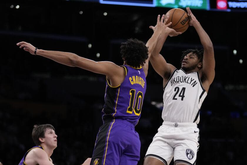 Los Angeles Lakers guard Max Christie (10) defends against Brooklyn Nets guard Cam Thomas.