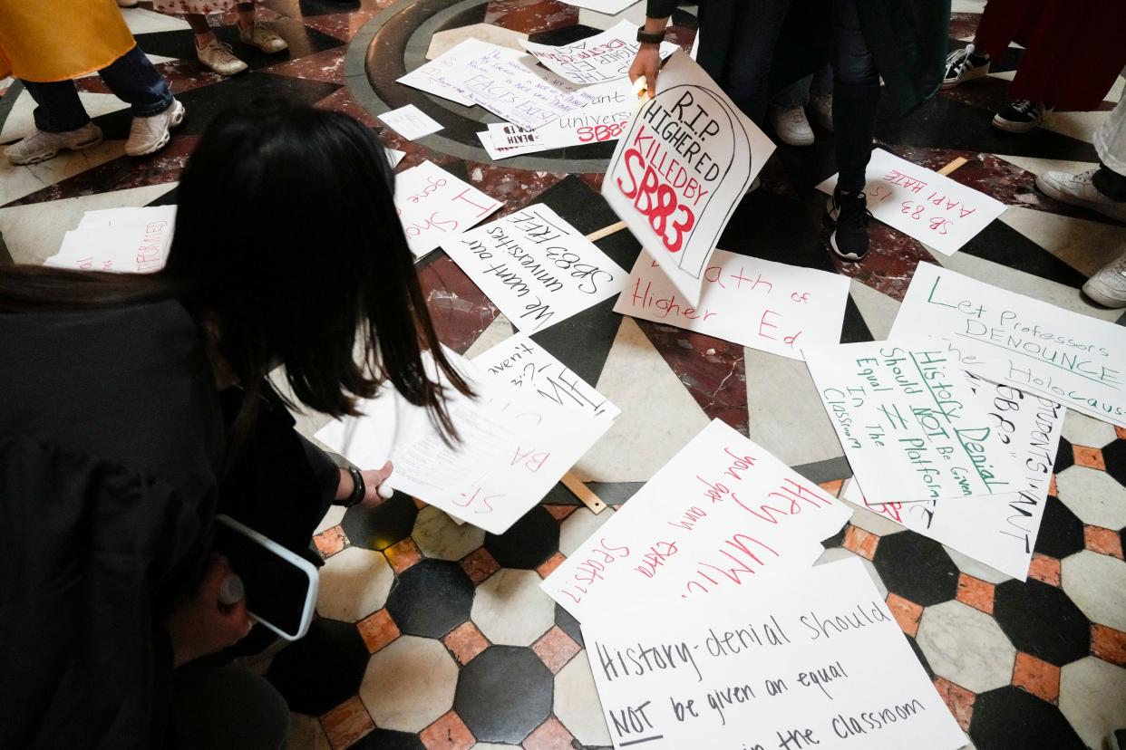 Jun 14, 2023; Columbus, Ohio, USA;  Protesters return their signs after protesting Senate Bill 83 at the Ohio Statehouse. Senate Bill 83 is a higher education bill and would substantially alter how college campuses function with changes to collective bargaining agreements, diversity equity and inclusion policies and programs, and policies about controversial beliefs, among others.