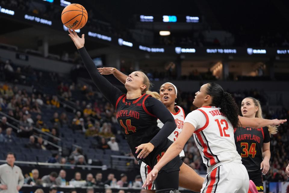 Maryland's Allie Kubek shoots as Ohio State's Cotie McMahon and Celeste Taylor (12) defend on Friday.