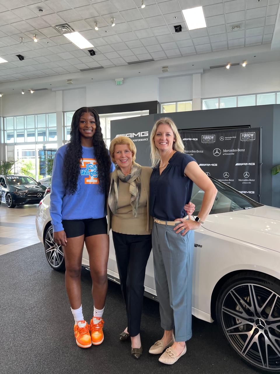 Rickea Jackson, left, poses with Ann Baker Furrow and Lady Vols coach Kellie Harper at Mercedes-Benz of Knoxville, where Jackson signed in April. Her NIL deal is the largest to date for a Lady Vol.